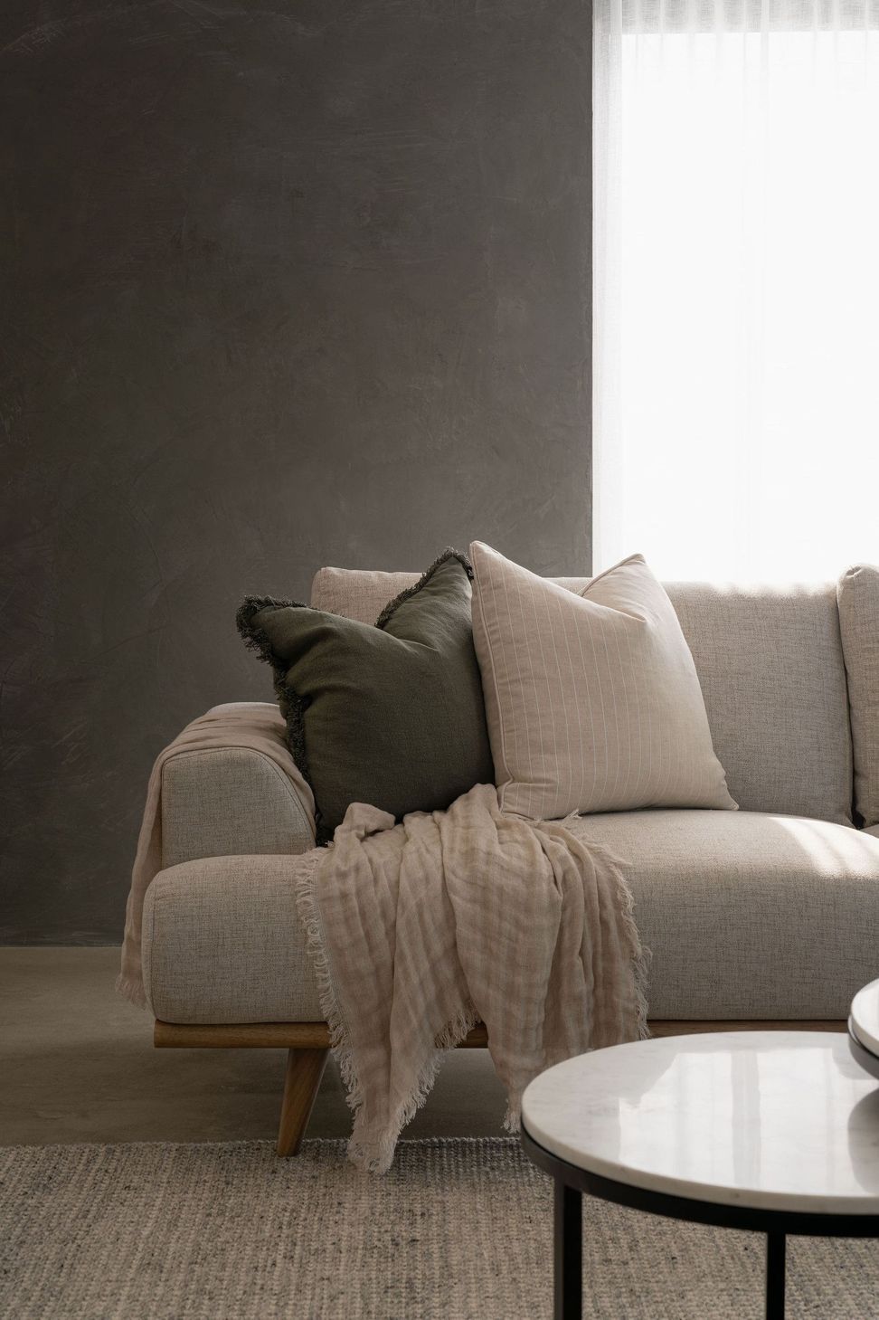 The Smith - Living Room. Soft linen sofa with layered cushions.