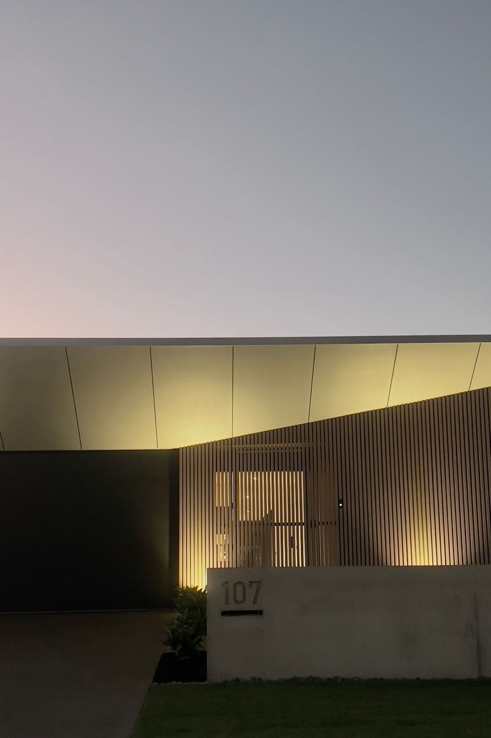 Bells Esplanade - Exterior. Fine roof edge lit at dusk.