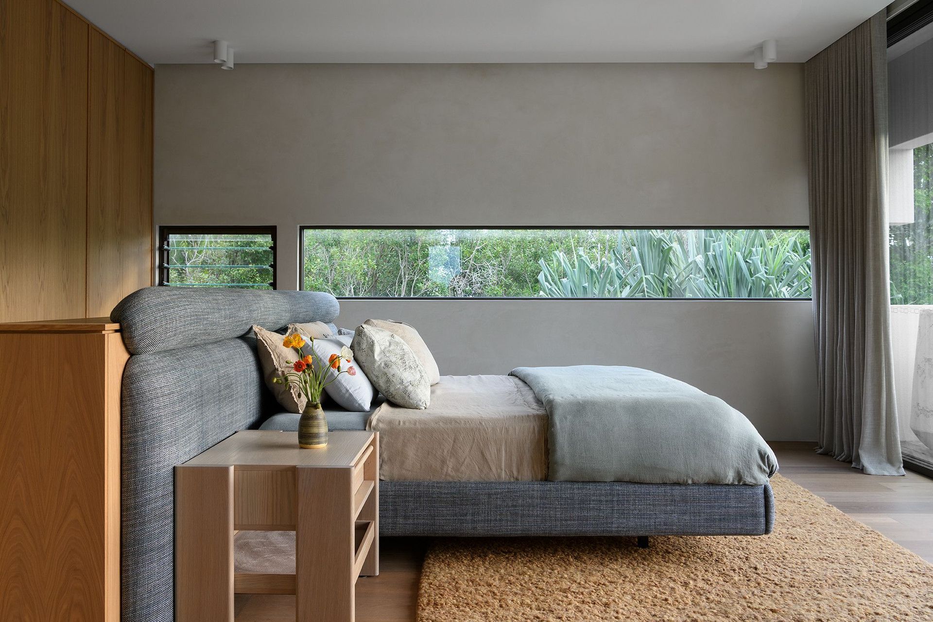 Villa Solare - Bedroom. Main bedroom with layered linen and a garden outlook.