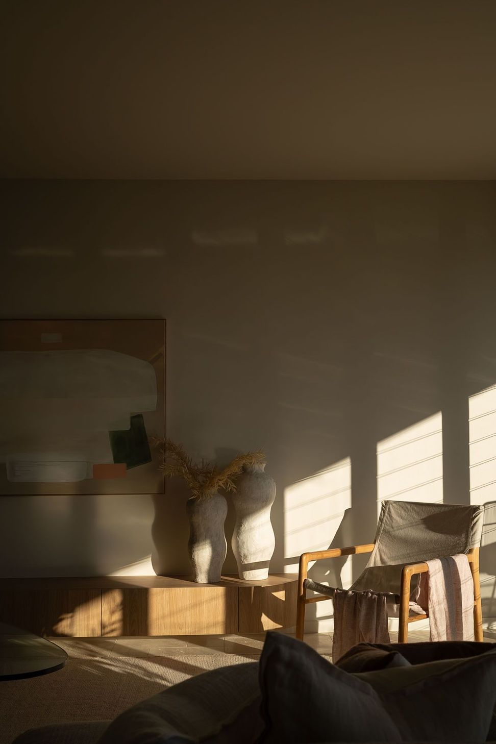 Warrego - Living Room. Shadows falling across a styled console.