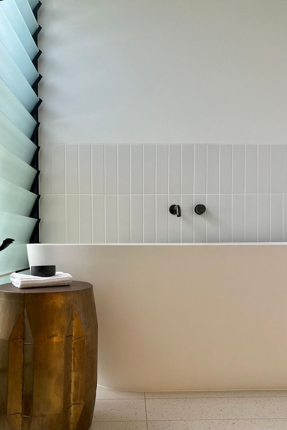Bells Esplanade - Bathroom. Wall mounted tapware above a white vanity with louvres.