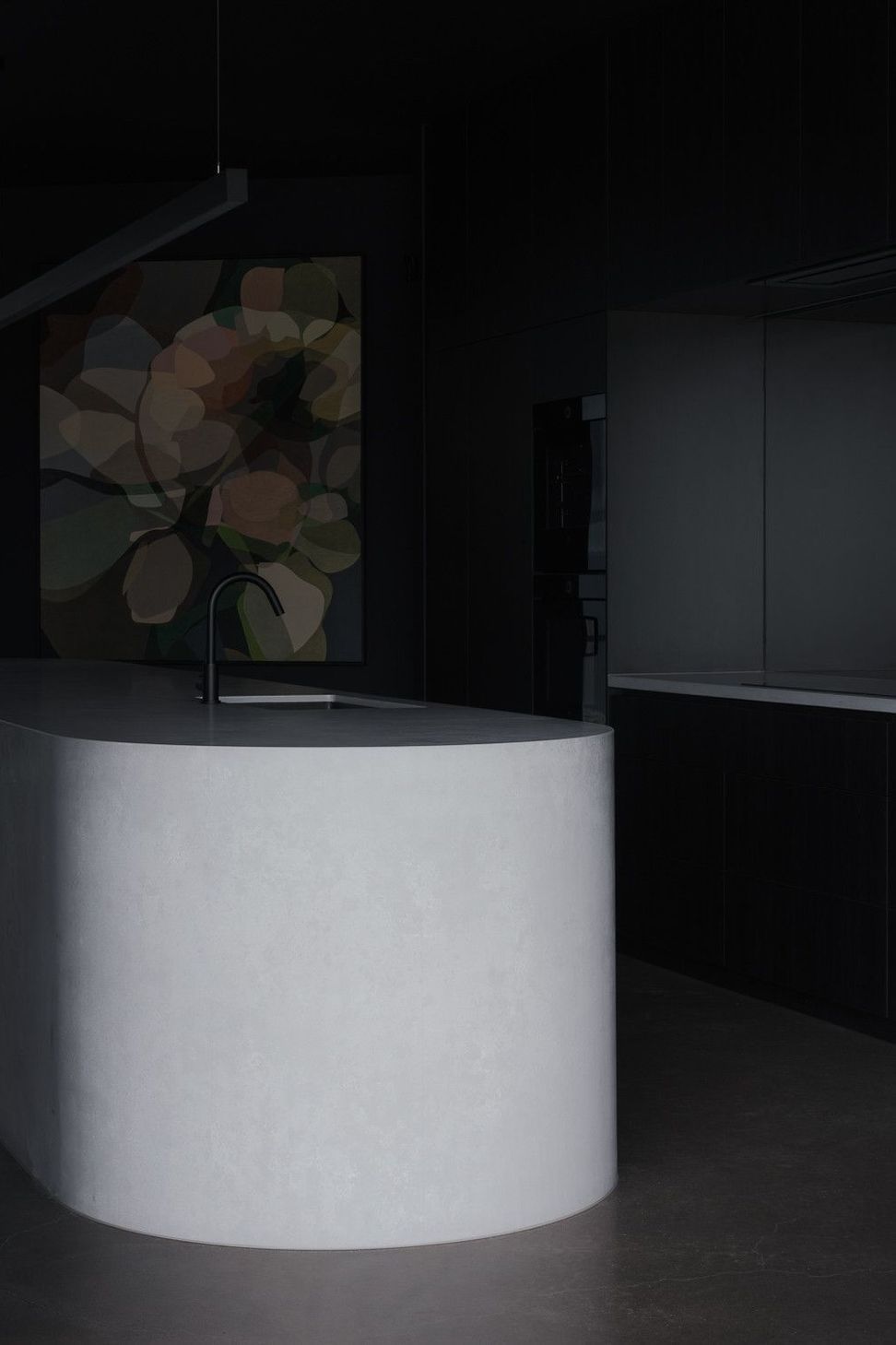 0042 Residence - Kitchen. Sculptural curved island end set against dark joinery and artwork.