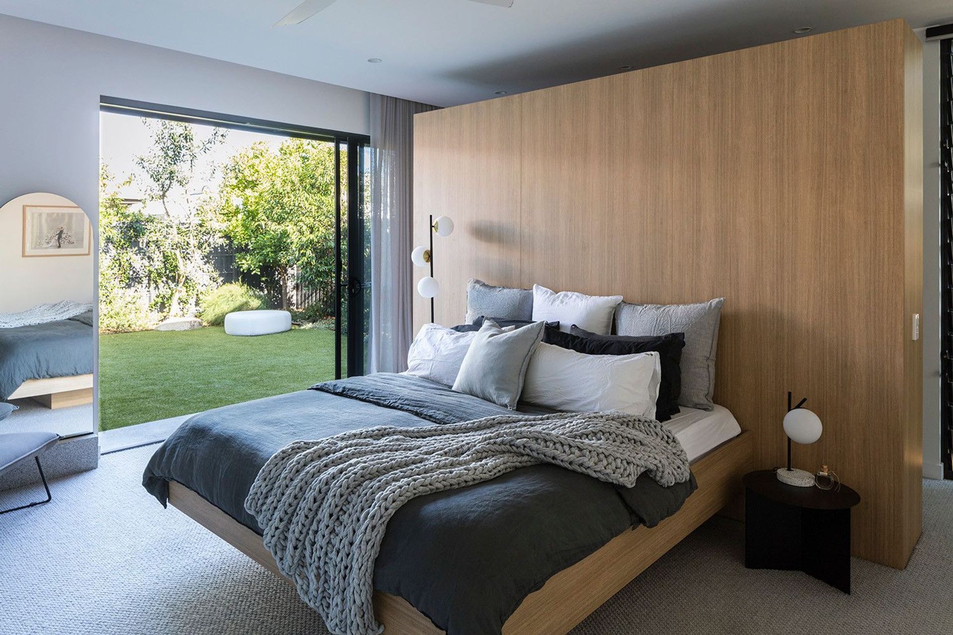 Morrison Residence - Bedroom. Bedroom with a timber feature wall and garden views.