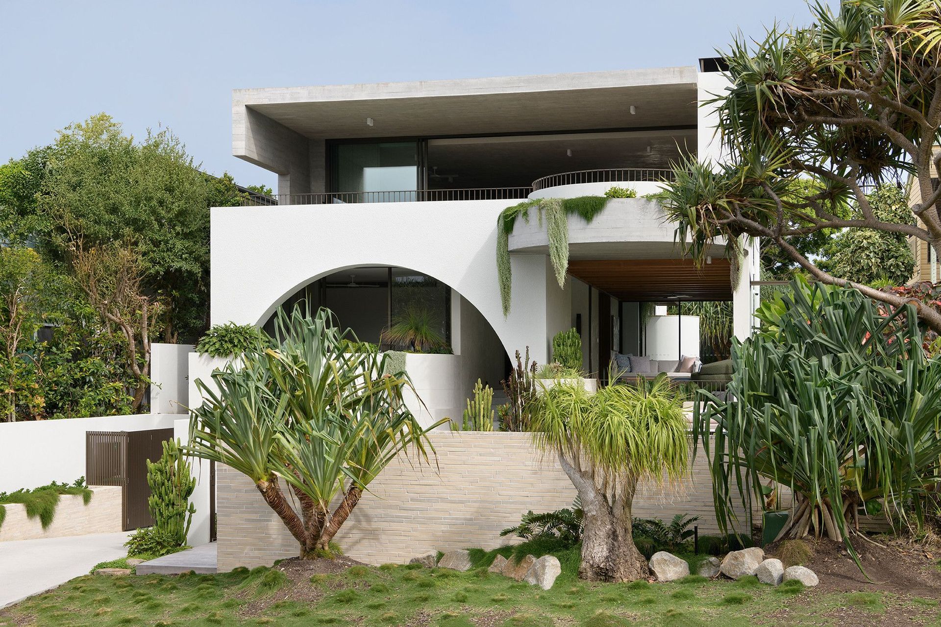 Villa Solare - Exterior. White arch and floating upper level above the front garden.