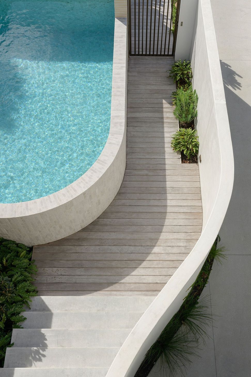 Villa Solare - Pool. Sweeping pool edge and timber deck from above.