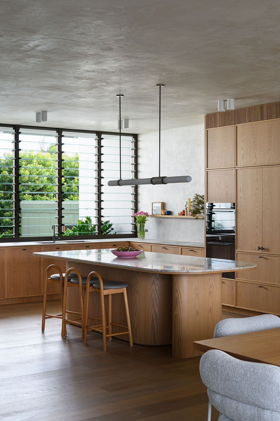 Villa Solare - Kitchen. Kitchen island with louvred windows to the garden.