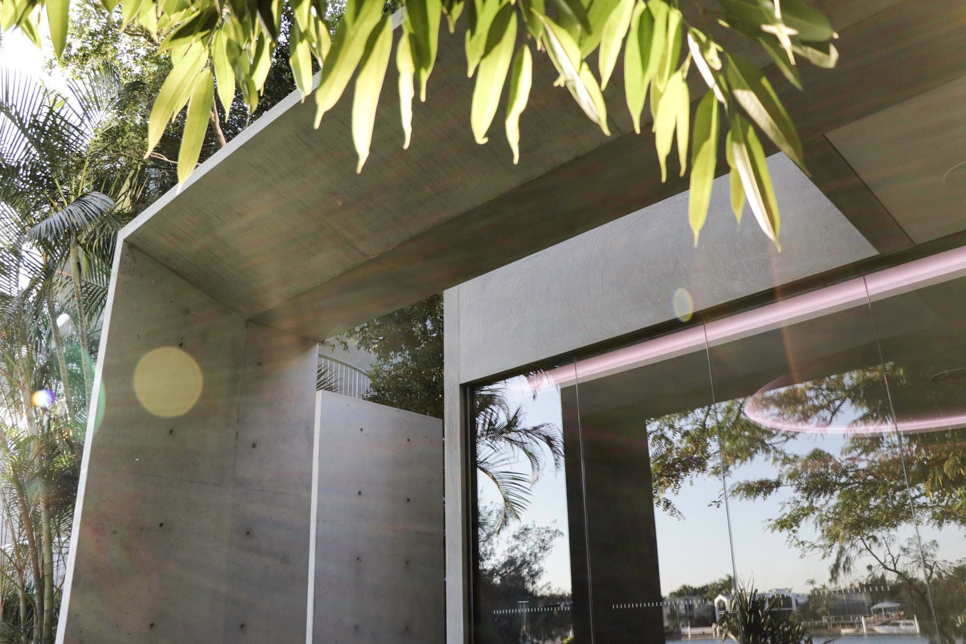 McGovern Residence - Exterior. Concrete portal framing lush garden views.