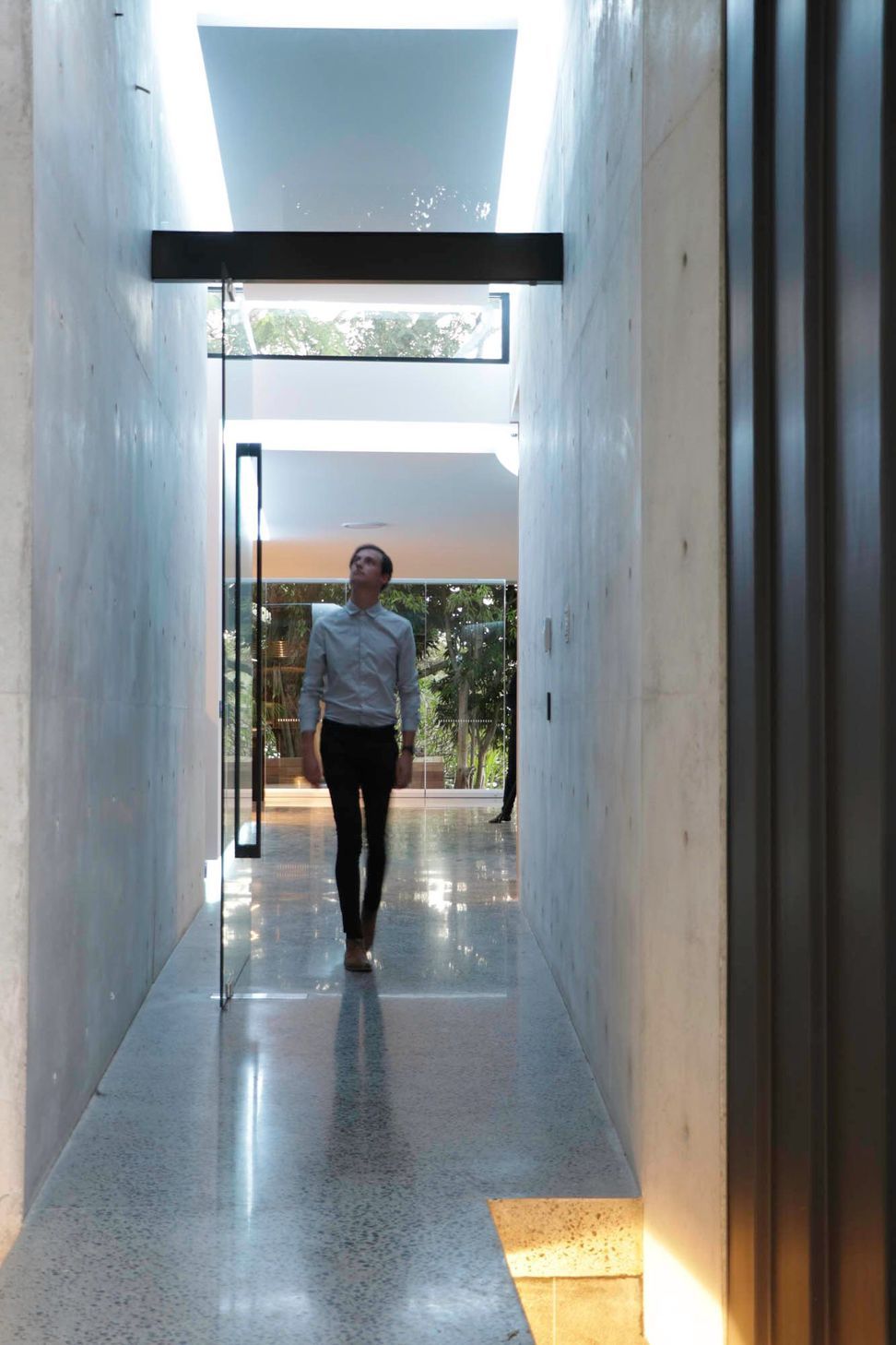 McGovern Residence - Hall. Concrete corridor opening to the courtyard light.