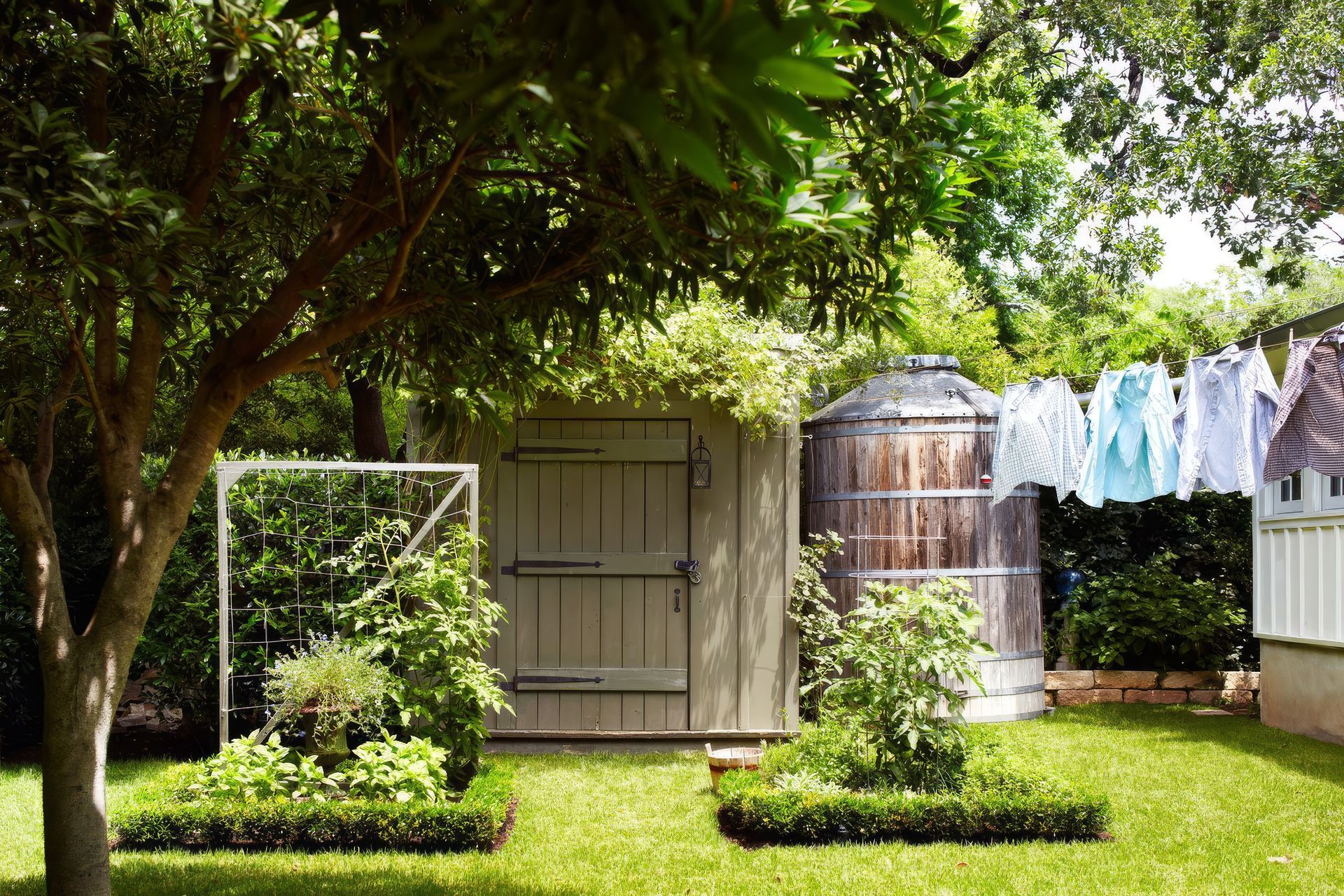 12HistoricHouseCuppettKilpatrickArchitectureandInteriorDesignaustin-tx-garden-shed-rainwater-tank-manicured-planters-upscaled-by-Replicate.jpg