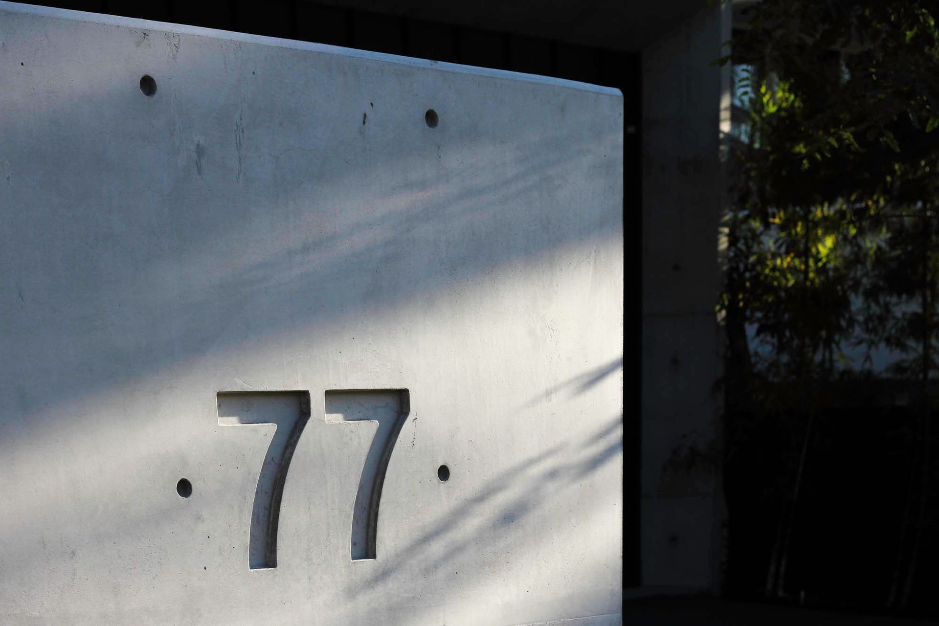 McGovern Residence - Exterior. House number cast into an off-form concrete wall.