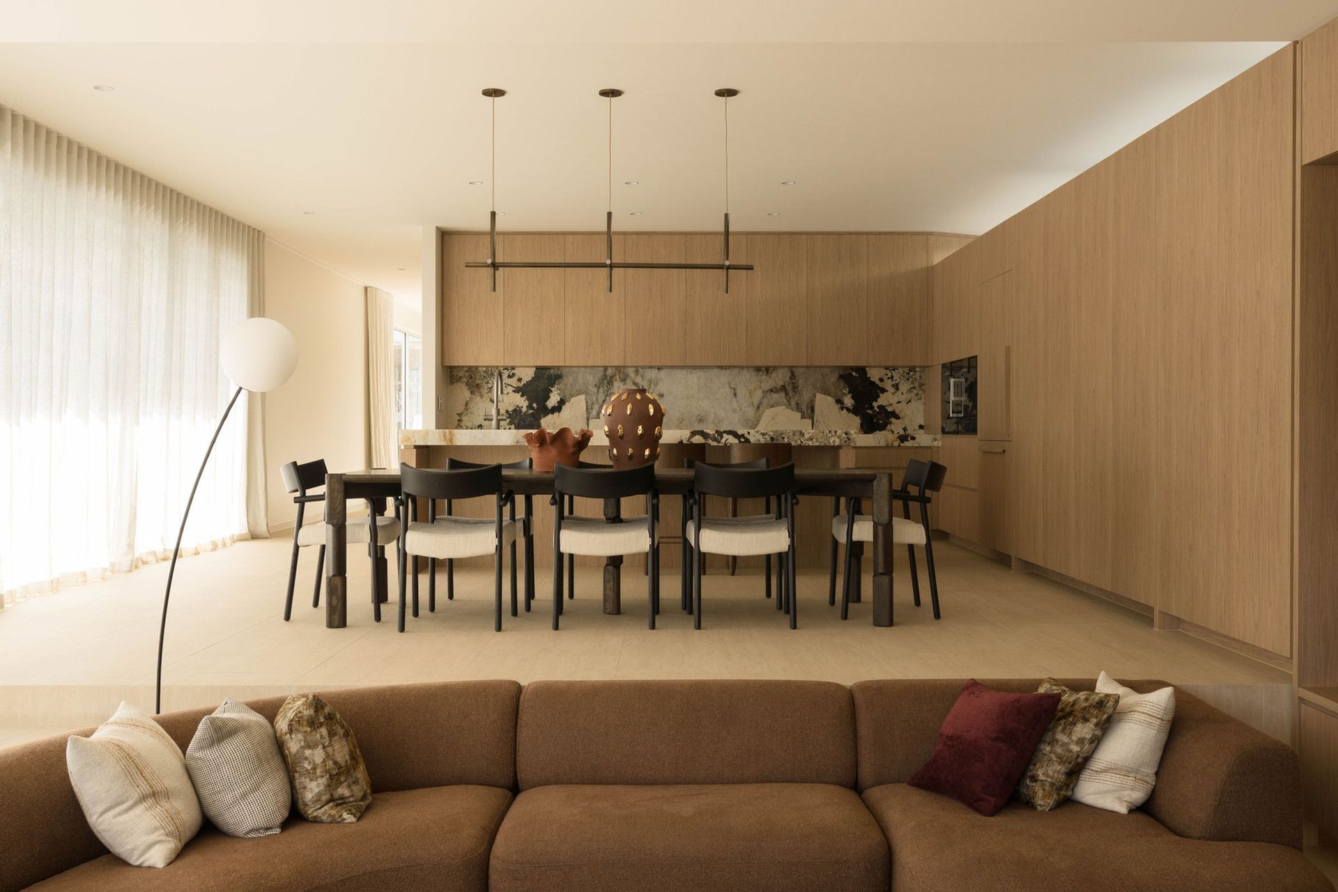 Henderson - Living Room. Sunken lounge and dining beneath warm timber joinery.