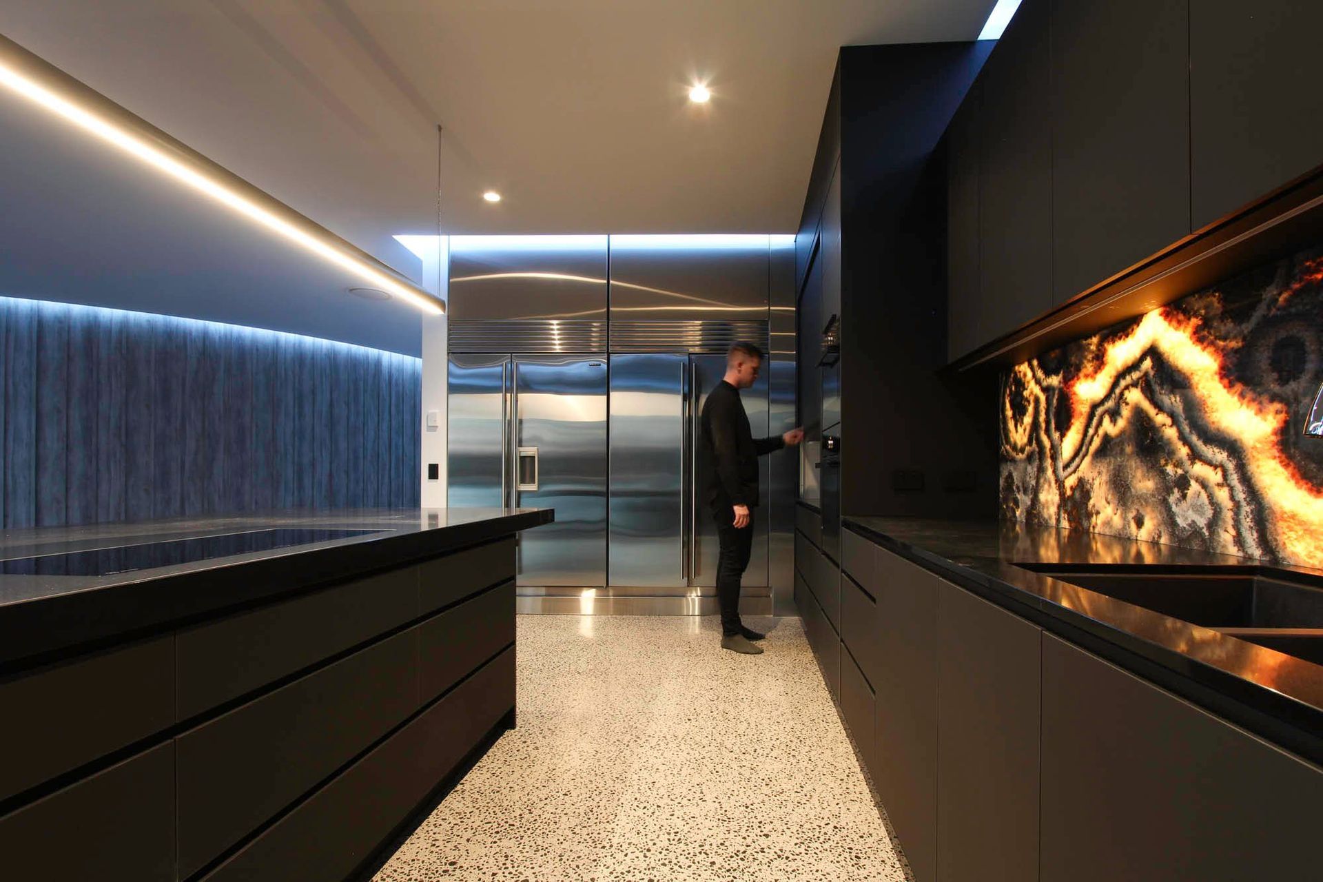 McGovern Residence - Kitchen. Kitchen with a backlit onyx feature and dark joinery.