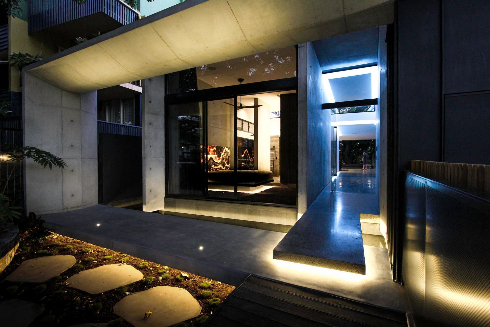McGovern Residence - Entry. Stepping stones leading to the lit entry at night.