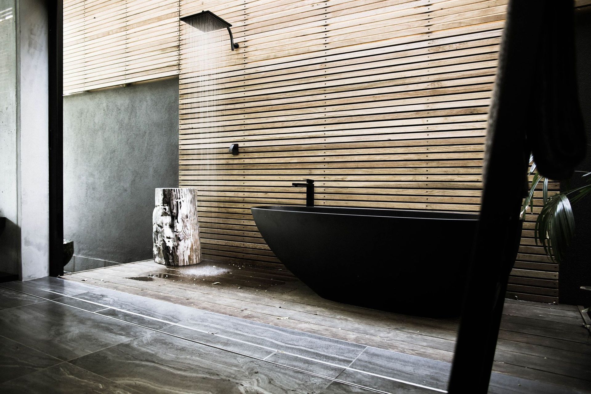 McGovern Residence - Bathroom. Freestanding black bath against timber battens.