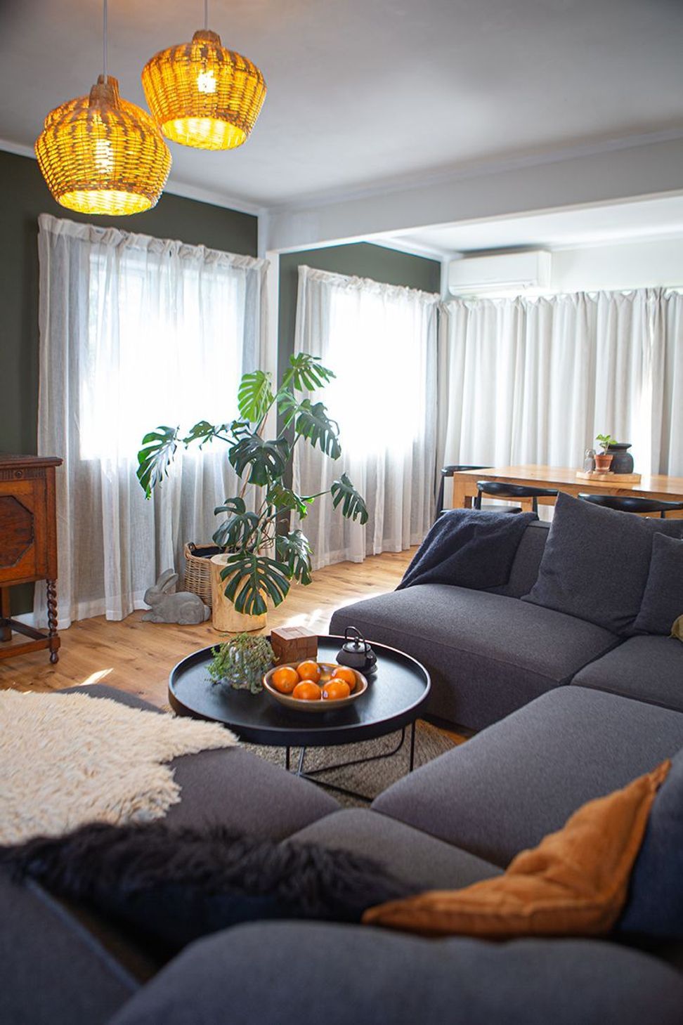 A large homely sofa for a growing family, separates the living from dining and kitchen spaces.