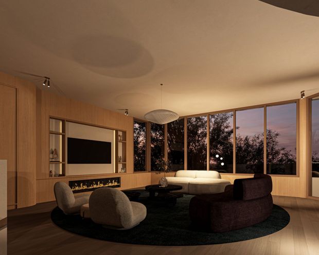 Warm, moody contemporary living room with extensive timber wall panelling and built-in media joinery, a linear fireplace beneath the television, curved upholstered lounge chairs, a cream sofa, dark sculptural seating, and a large oval dark rug. Full-height corner glazing overlooks silhouetted trees at dusk, while a sculptural pendant and discreet track lighting provide illumination.