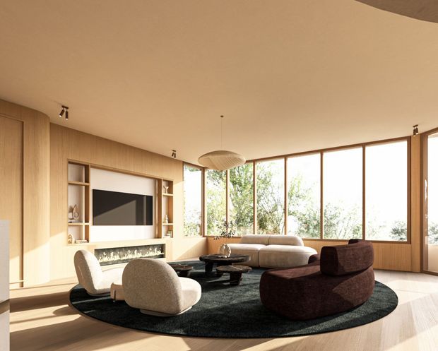 A warm, sunlit contemporary living room with extensive timber wall panelling and built-in media shelving surrounding a television and linear fireplace. Floor-to-ceiling timber-framed glazing opens to leafy views. The room contains a large curved sectional sofa, sculptural lounge chairs, dark round coffee tables, a large oval black rug, and a suspended woven pendant light.