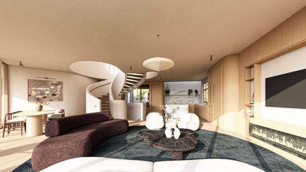 A spacious contemporary open-plan living room with a curved dark sectional sofa, sculptural round coffee table, large teal rug, suspended pendant lighting, extensive light-wood built-in cabinetry, a wall-mounted television and linear fireplace. A dramatic curved staircase connects the living area to the upper level, while a dining area and kitchen are visible in the background. Warm natural light fills the room.