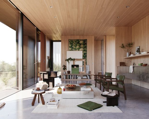 A refined open-plan living room with full-height glazing along one side, warm timber-lined walls and ceiling, polished concrete flooring, and a layered seating arrangement around a low rectangular coffee table. Built-in shelving, plants, books, artwork, and a fireplace or display wall add detail. The room has a calm, natural, contemporary character with strong indoor-outdoor light.