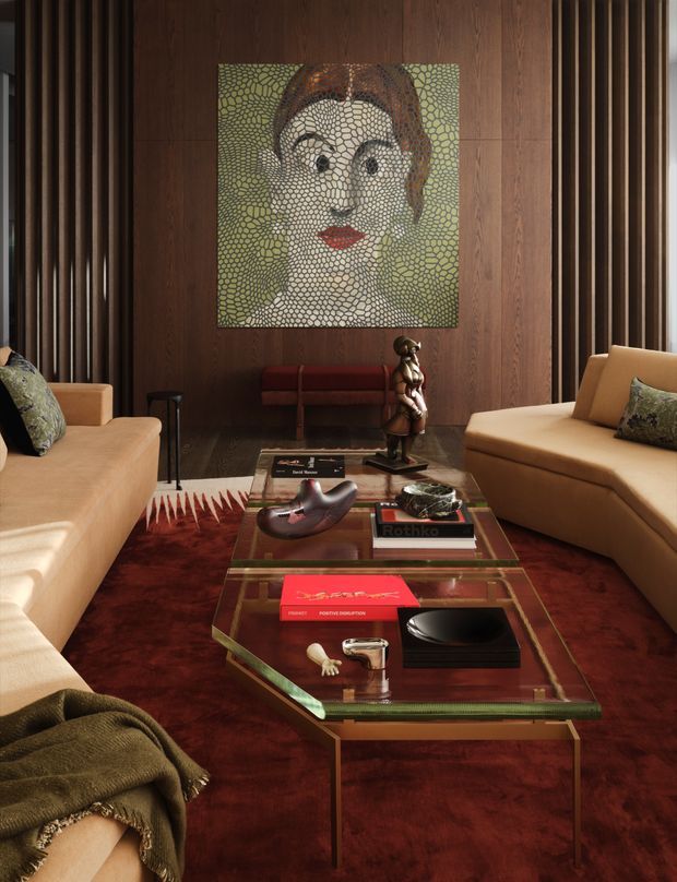 A richly styled living room with a warm, dramatic palette. Two cream upholstered sofas face a transparent glass coffee table with metallic framing, layered books and sculptural objects. Deep burgundy carpeting, dark wood wall panelling, and vertical fluted timber details create a luxurious backdrop, with a large mosaic portrait artwork as the focal point. A console or bench and a sculptural floor object sit beneath the artwork.