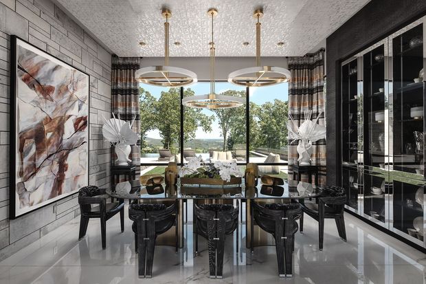 A sophisticated dining room with a large glass dining table surrounded by sculptural dark dining chairs. Floor-to-ceiling glazing opens to a leafy outdoor view, while a grey stone or concrete-look feature wall, dramatic abstract artwork, mirrored display cabinetry, patterned curtains, and multiple circular pendant lights create a luxurious, high-contrast interior.