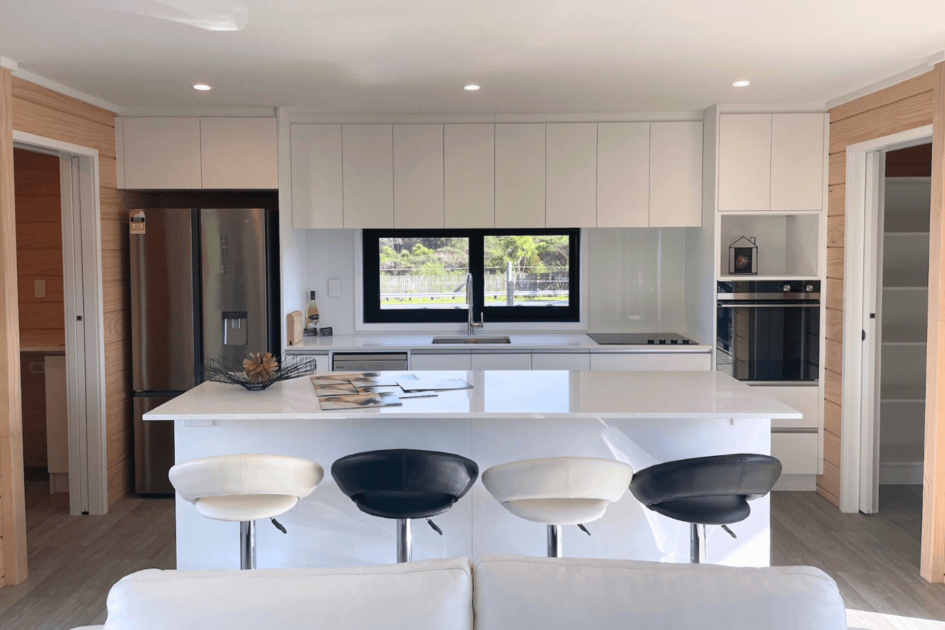 Thoughtfully Designed Kitchen and adjacent laundry (left) &amp; pantry (right)