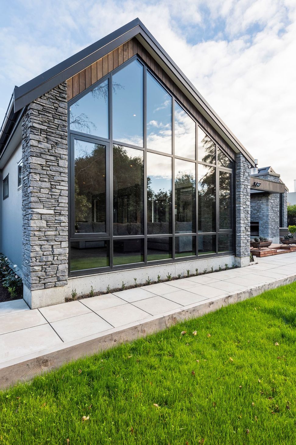 A wall of glazing highlights the asymmetrical angle of the livings space.