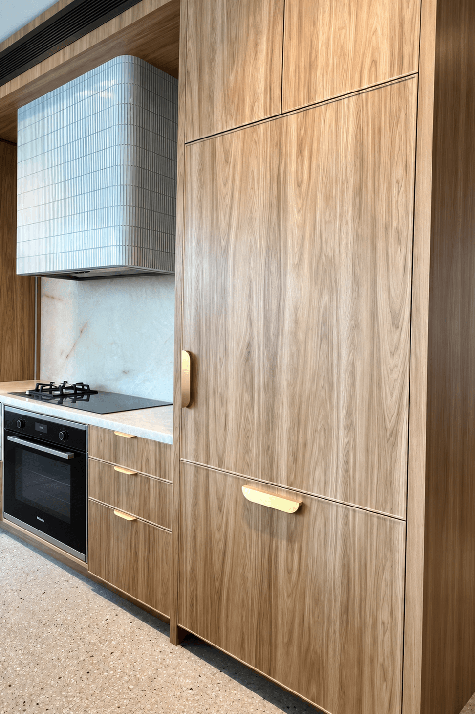 Modern-Walnut-Kitchen-with-Brass-Details.png