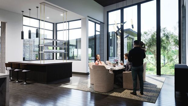 Bright, sophisticated open-plan residential interior combining a contemporary kitchen and dining area. The kitchen features a large dark ribbed island with stools, pendant lighting, extensive glazing, and light shelving. A dining table with upholstered chairs sits beside tall floor-to-ceiling windows and doors overlooking greenery. Dark timber flooring, white walls, black-framed glazing, and a dark ceiling create a refined high-contrast scheme.