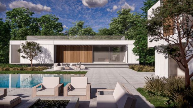 A contemporary single-storey residence viewed from the landscaped pool terrace. The flat-roofed white facade features extensive glazing, a recessed entry or living zone with vertical timber screening, and broad pale paving leading toward the house. A swimming pool, minimalist outdoor lounge furniture, ornamental grasses, mature trees, and a separate white cubic building volume frame the scene.