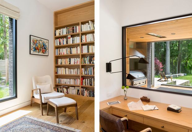 Split-view interior photograph showing a refined timber-lined home office and reading area. The left side features a tall built-in timber bookshelf filled with books, a light upholstered lounge chair and ottoman, artwork, and a patterned rug beside large glazing. The right side shows a timber desk and built-in work surface, leather office chair, architectural wall-mounted lamp, and a large internal or external-facing window overlooking a leafy garden. The space is bright, warm, and carefully detailed with natural timber joinery.