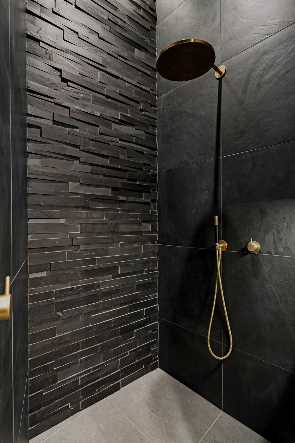 "An exquisite 'Island Stone' feature wall extends dramatically into the unused attic space, achieving an impressive four-meter floor-to-ceiling height. Dimmable recessed ceiling strip lighting enhances the atmosphere, creating a sophisticated and inviting ambiance throughout the area."