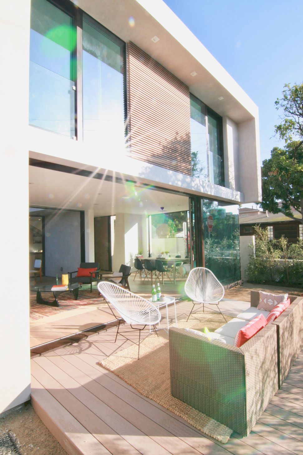 Floor-to-ceiling glass sliders connect the ground-floor interiors with a patio, expanding the living area and maximizing the home’s indoor/outdoor connection.