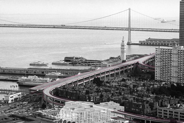 A black-and-white aerial architectural and urban view of a dense waterfront district, showing elevated curving roadways, waterfront piers and ferries, a suspension bridge across the bay, and closely packed high-rise and low-rise buildings. Pink/red lines highlight sections of the roadway and a translucent white building mass appears in the foreground, suggesting an architectural visualization or redevelopment proposal over an existing cityscape.