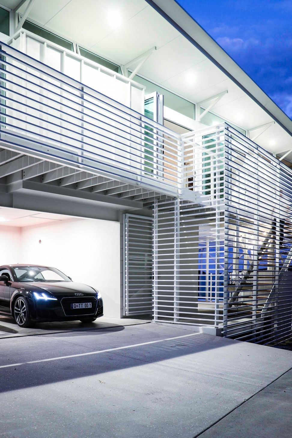 105 Residence - Garage. Car in the white garage beneath the slatted deck.