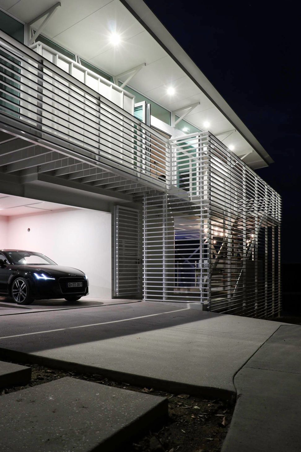 105 Residence - Garage. Garage and slatted screen lit from within.