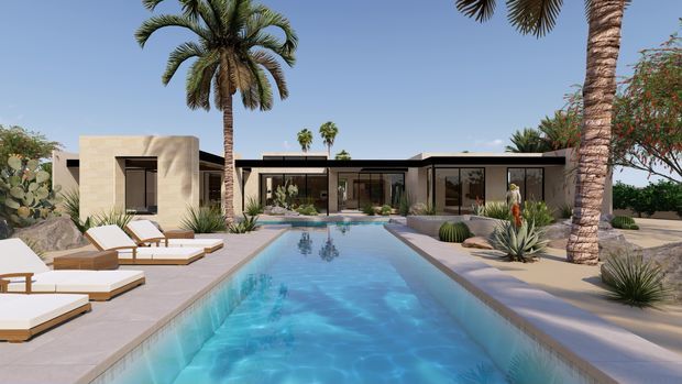 A single-storey modern courtyard-style residence viewed from the pool, with extensive glazing, flat rooflines, pale stucco or concrete walls, and a long rectangular swimming pool bordered by pale paving. Tall palms, agave-like planting, cacti, and other drought-tolerant landscaping create a warm desert resort setting. White and wood-framed loungers line the pool deck.
