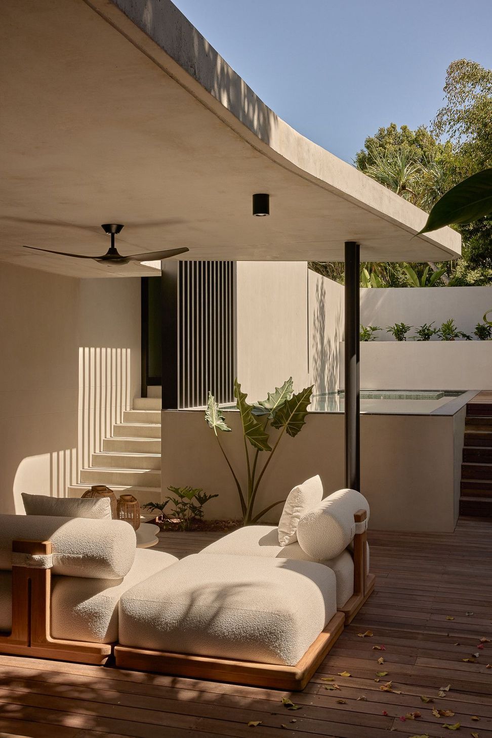 Wildflower Residence - Patio. Outdoor lounge under the curved canopy, open to the courtyard.