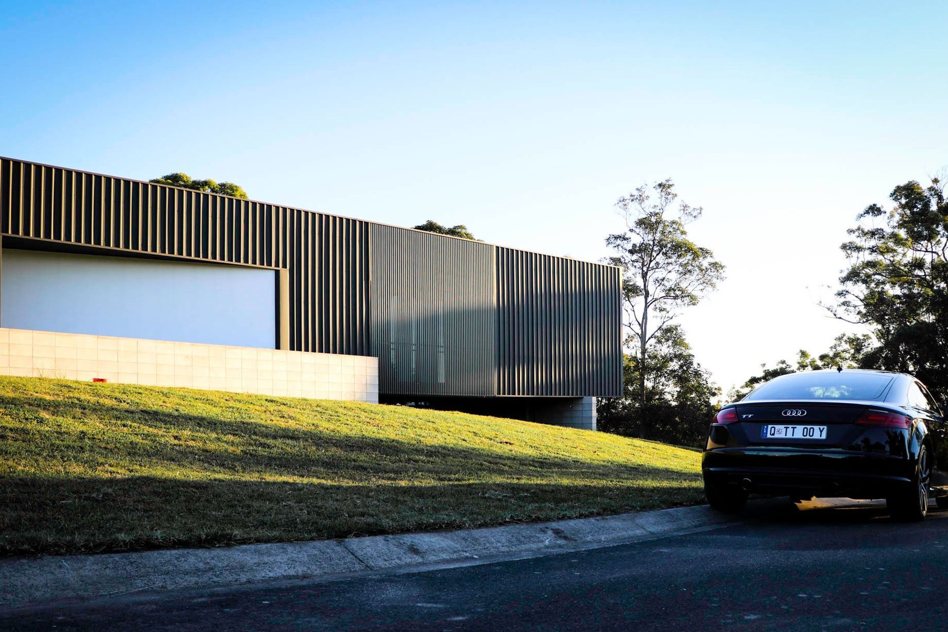 Seabrook and Borg Residence - Exterior. The home stretched along the hillside above the driveway.