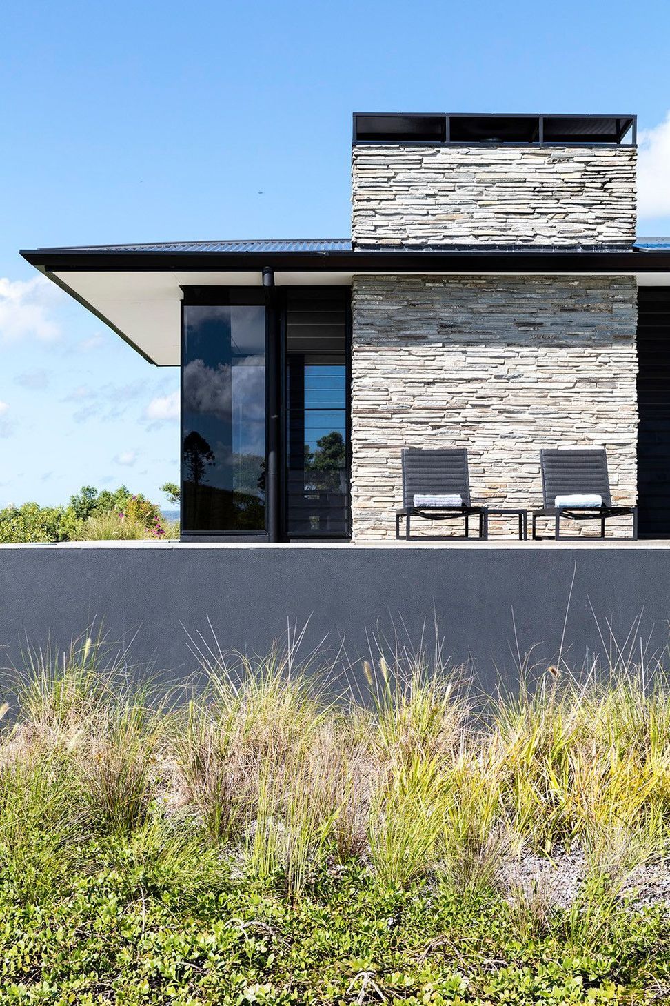 Clark Residence - Patio. Outdoor seating beside the stacked stone wall.