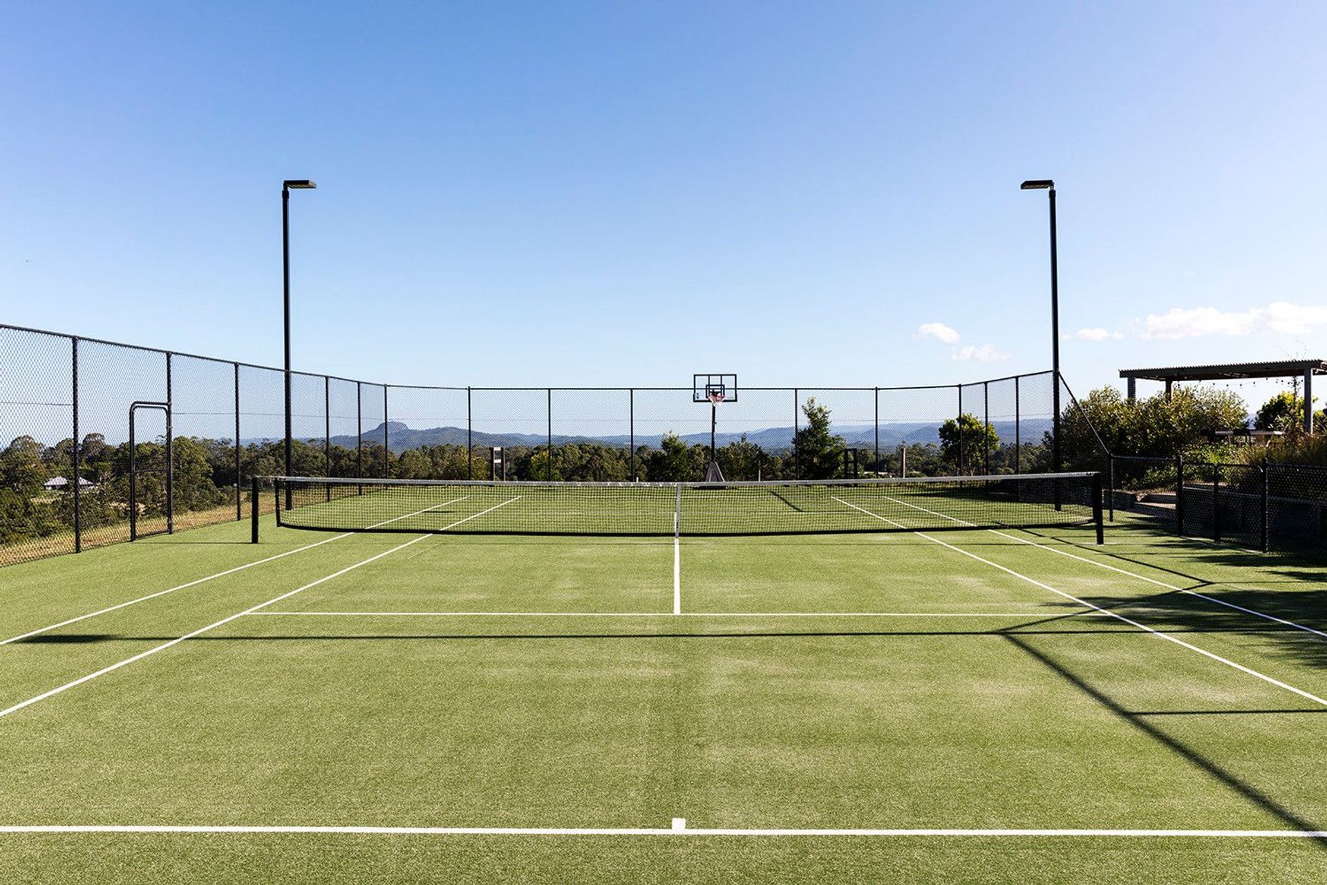 Clark Residence - Garden. Grass tennis court set into the landscape.