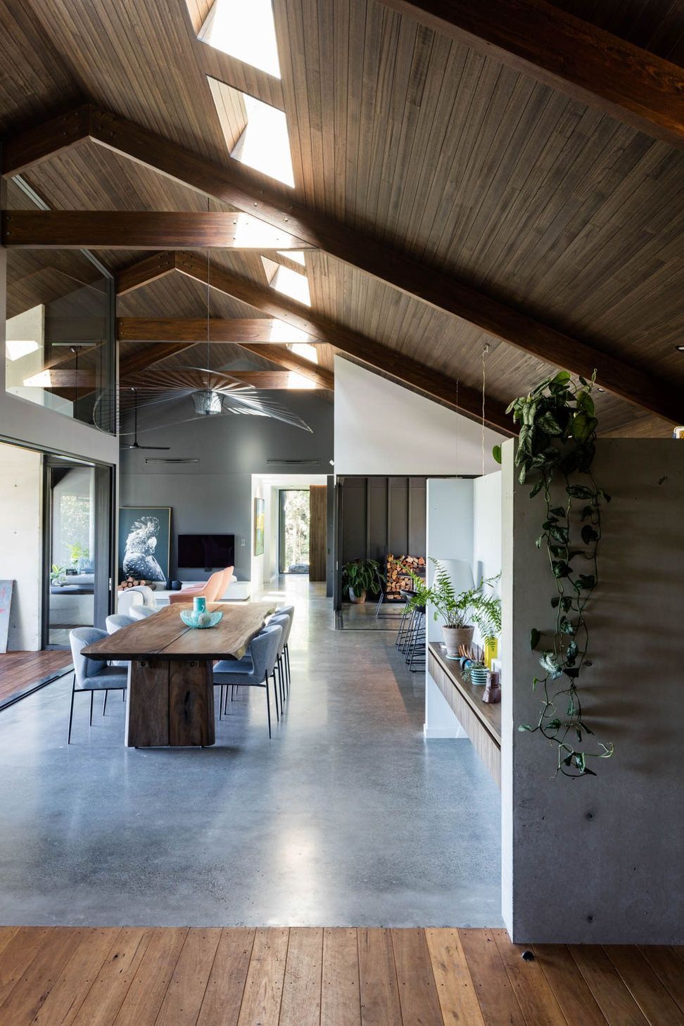 Watson Residence - Dining Room. Long timber dining table beneath exposed rafters.
