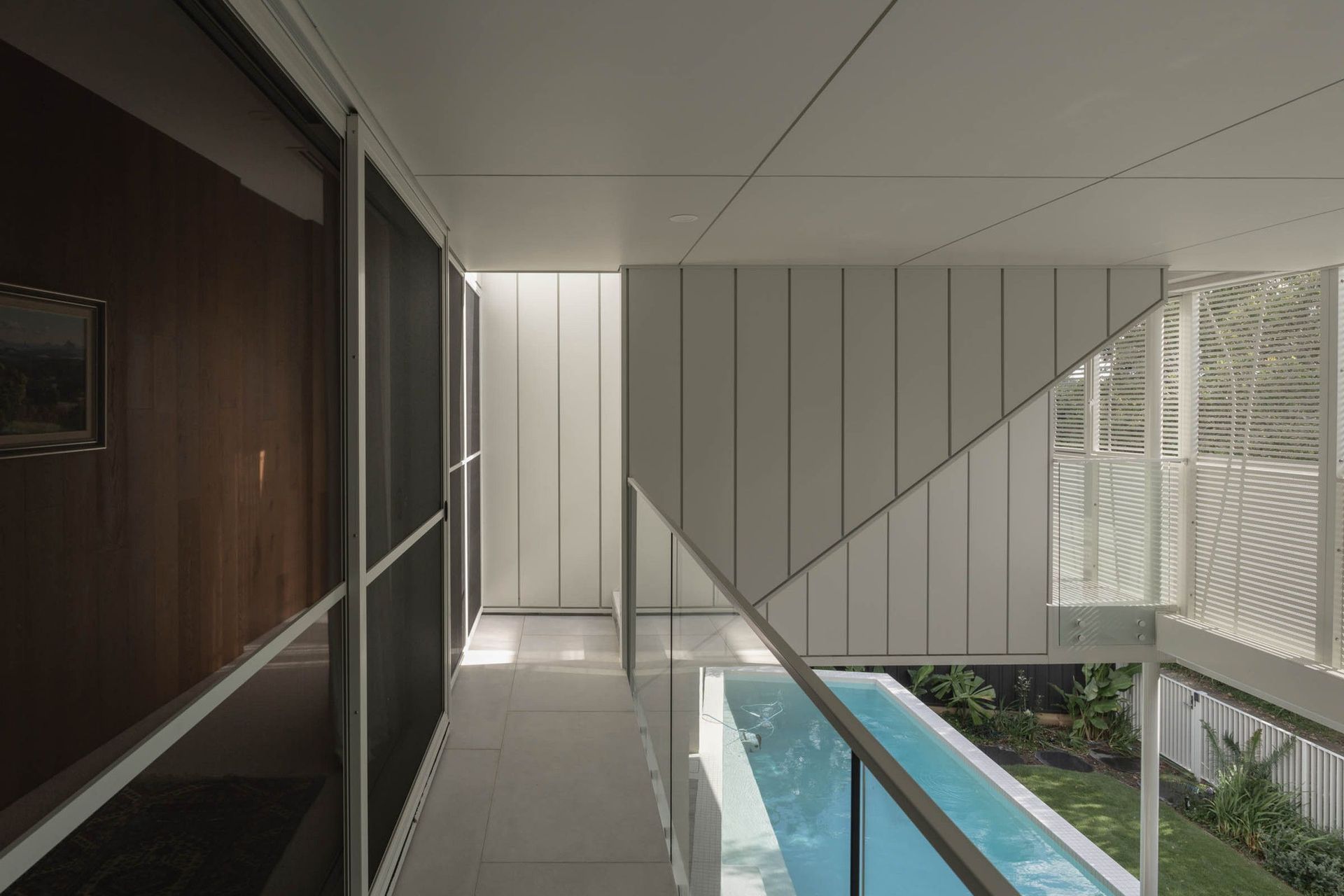 Eleutheria - Pool. Narrow pool lit from above beside the timber walls.