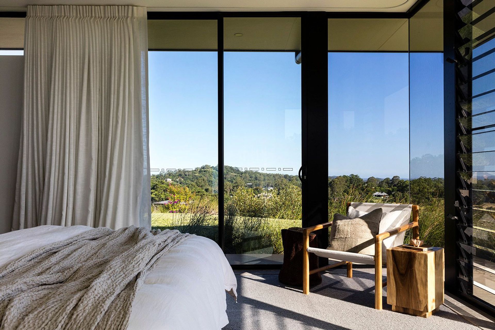 Clark Residence - Bedroom. Bedroom with sheer curtains and views to the hills.