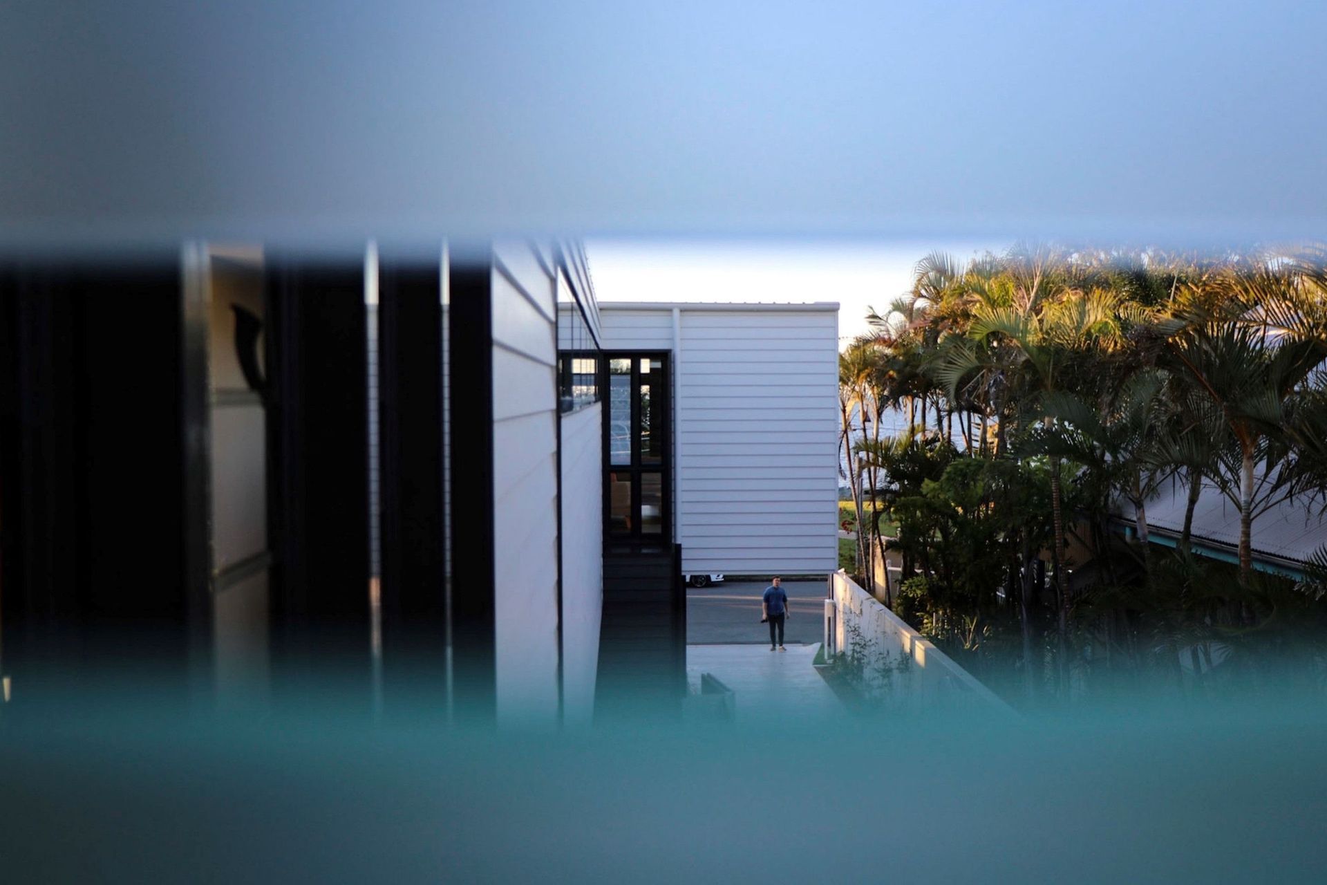 Kruger Residence - Exterior. Reflections across the glazing and garden.