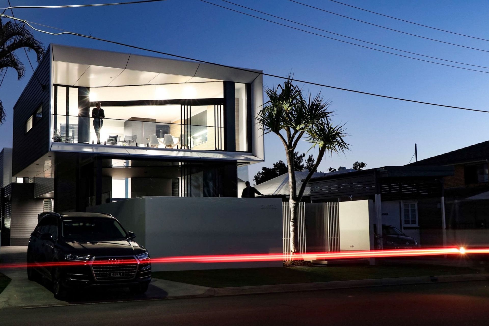 Kruger Residence - Exterior. Street frontage at dusk with light trails.