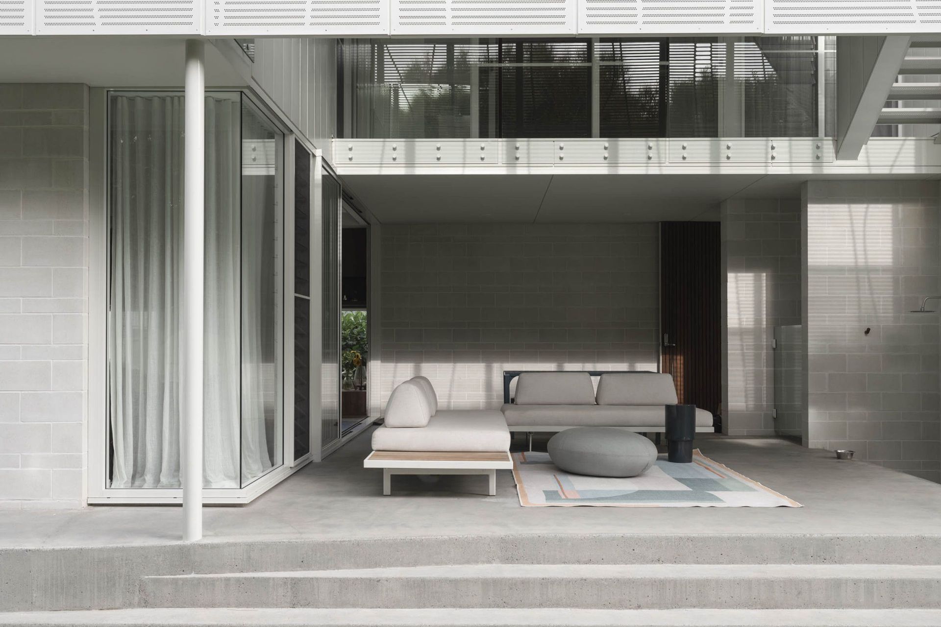 Eleutheria - Patio. Outdoor lounge setting under the cantilevered upper floor.