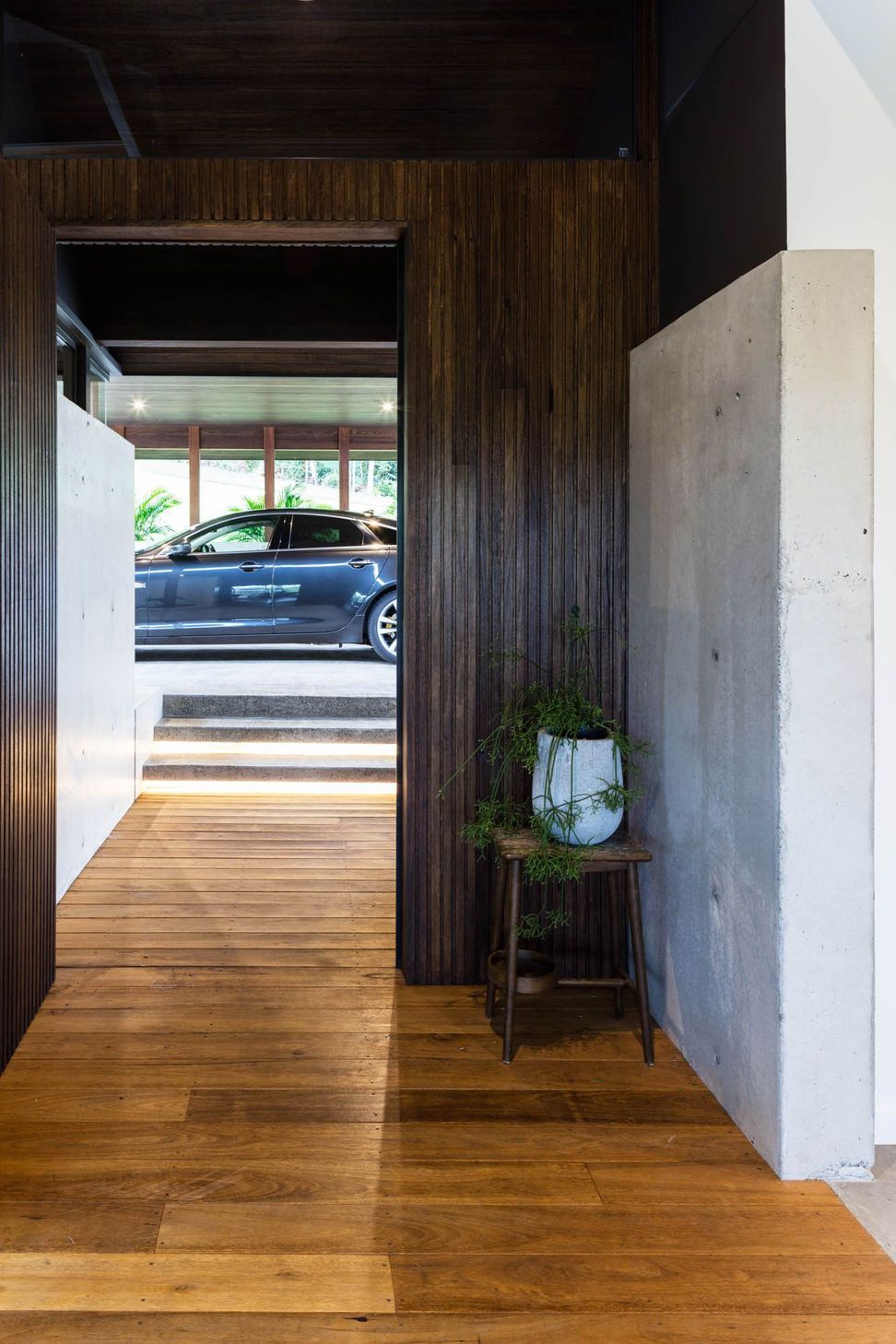 Watson Residence - Entry. Timber clad entry and concrete wall beside the carport.