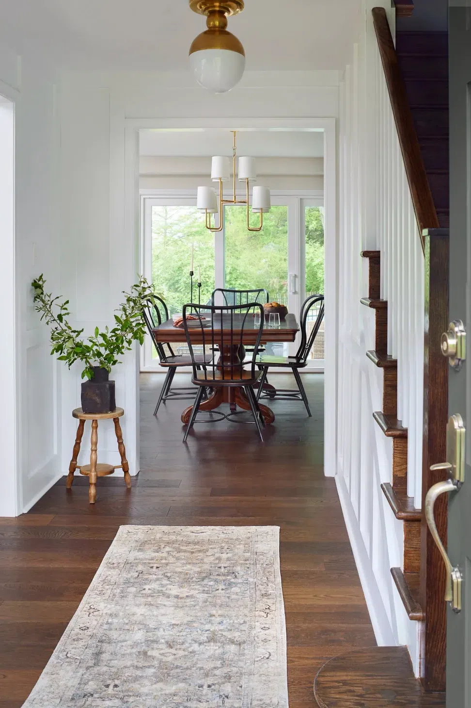 entry-dark-hardwood-floors-board-batten-white-wall-dining-room-sharp-and-grey-interiors-philadelphia-pa.webp