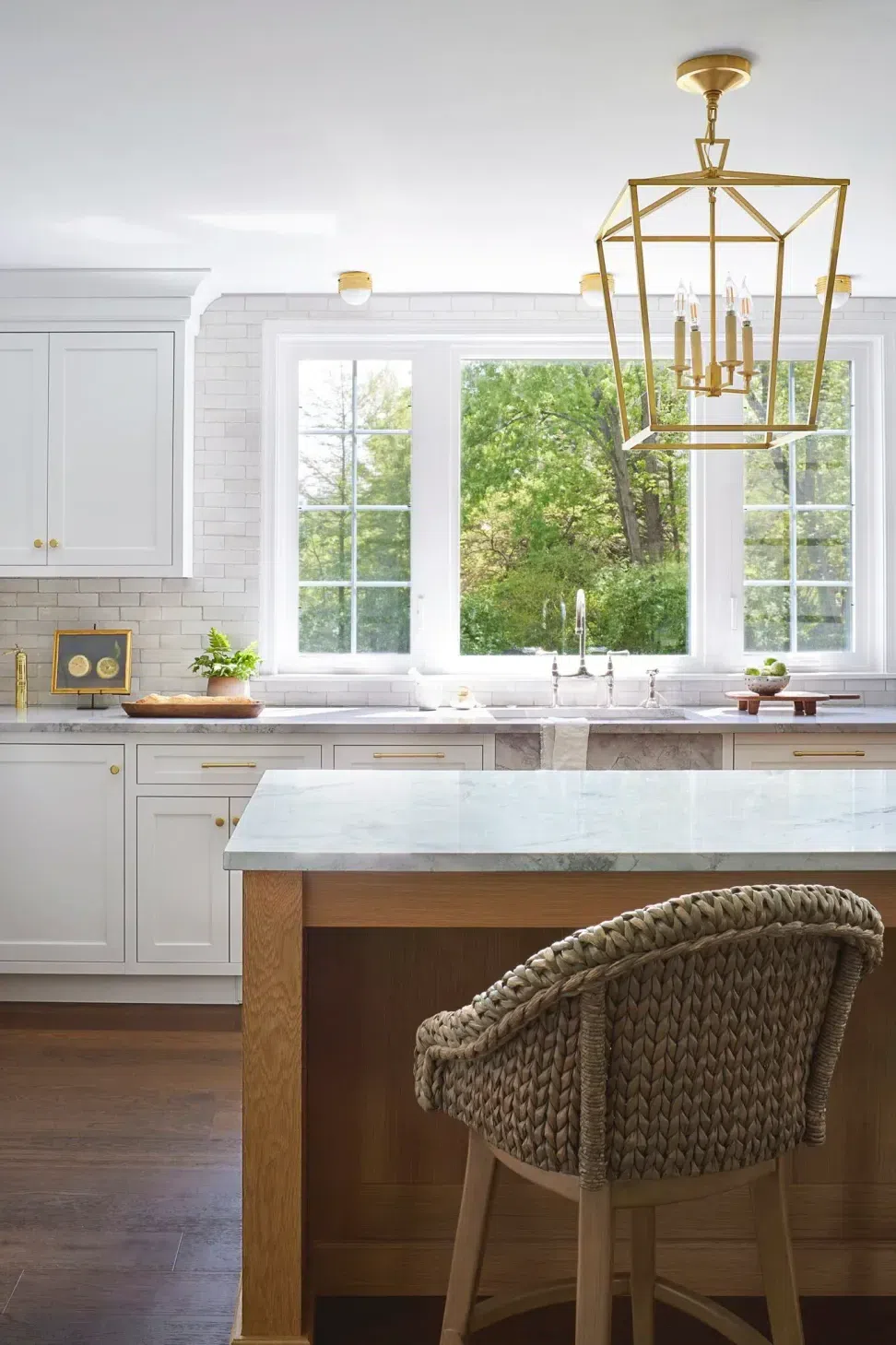 kitchen-renovation-white-wood-cabinets-white-subway-tile-backsplash-bronze-pendants-wood-island-sharp-and-grey-interiors-philadelphia-pa-v2.webp